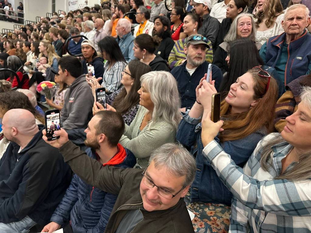 Parents and other observers watch students enter the George Houston Gymnasium for Juneau-Douglas High School: Yadaa.at Kalés graduation ceremony Sunday, May 25, 2025. (Mark Sabbatini / Juneau Empire)