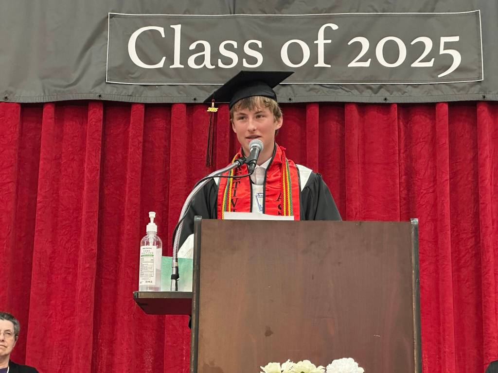 Ferguson Wheeler gives one of three senior student speeches during Juneau-Douglas High School: Yadaa.at Kalés graduation ceremony Sunday, May 25, 2025. (Mark Sabbatini / Juneau Empire)