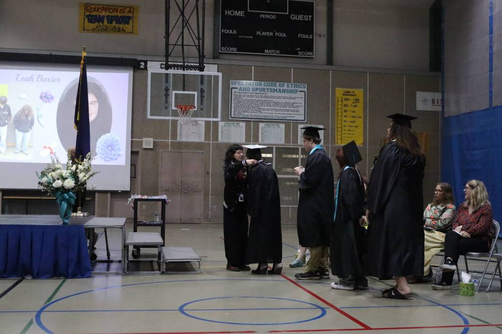 Alicia Maryott, an education counselor, helps a graduate put on a candy lei during Yaaḵoosgé Daakahídi High Schools graduation ceremony Sunday, May 25, 2025, at the Dzantiki Heeni campus. Maryott is a counselor for the school through the Johnson OMalley Program operated by the Central Council of the Tlingit and Haida Indian Tribes of Alaska. (Ellie Ruel / Juneau Empire).