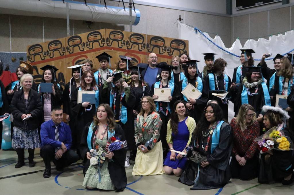 Graduates pose for a group photo with principal and advisors after Yaaḵoosgé Daakahídi High Schools graduation ceremony on Sunday, May 25, 2025, at the Dzantiki Heeni campus. (Ellie Ruel / Juneau Empire)