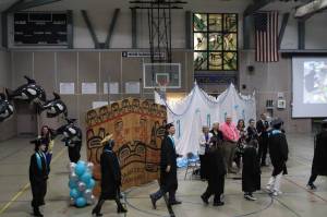 Yaaḵoosgé Daakahídi High Schools seniors enter the Dzantiki Heeni gymnasium during the schools graduation ceremony Sunday, May 25, 2025. (Ellie Ruel / Juneau Empire)