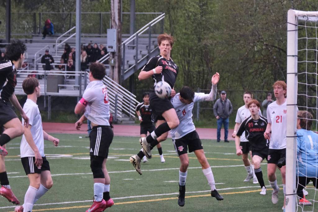 Juneau-Douglas High School: Yadaa.at Kalé senior Reed Maier connects with a corner kick that would score during Saturdays Crimson Bears senior appreciation game at Adair-Kennedy Memorial Park. (Klas Stolpe / Juneau Empire)