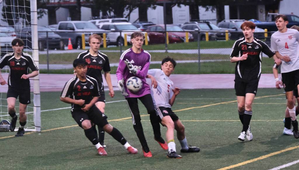Juneau-Douglas High School: Yadaa.at Kalé freshman keeper Callen Walker battles in a box scrum during Saturdays Crimson Bears senior appreciation game at Adair-Kennedy Memorial Park. (Klas Stolpe / Juneau Empire)