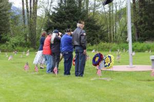 Volunteers salute wreaths at the Juneau Memorial Day Service hosted by American Legion Auke Bay Post #25 at Alaskan Memorial Park on Monday, May 26, 2025. (Ellie Ruel / Juneau Empire)