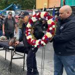 Ray Wilson (center), a Korea War veteran who served in the U.S. Army, helps place a wreath at the Southeast Alaska Native Veterans Memorial Park during a Memorial Day ceremony on Monday, May 26, 2025. (Mark Sabbatini / Juneau Empire)