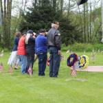 Volunteers salute wreaths at the Juneau Memorial Day Service hosted by American Legion Auke Bay Post #25 at Alaskan Memorial Park on Monday, May 26, 2025. (Ellie Ruel / Juneau Empire)
