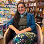 Olga Lijo Serans, owner of Hearthside Books, discusses its inclusion in USA Todays voting competition to determine the 10 Best Independent Bookstores in the U.S. at her Nugget Mall branch on Monday, May 26, 2025. (Mark Sabbatini / Juneau Empire)