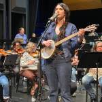 Juneau singer/songwriter Annie Bartholomew rehearses with the Juneau Symphony on Thursday, May 29, 2025, in the Juneau-Douglas High School: Yadaa.at Kalé auditorium. Two folk songs by Bartholomew about women during Klondike Gold Rush will be featured in rearrangements for orchestra during performances Saturday and Sunday. (Mark Sabbatini / Juneau Empire)