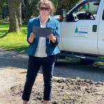 Juneau Assembly Member Christine Woll, standing in for Mayor Beth Weldon, reads a city proclamation celebrating the Evergreen Cemetery Arboretum and national Arbor Day on Monday, May 19, 2025. (Laurie Craig / For the Juneau Empire)