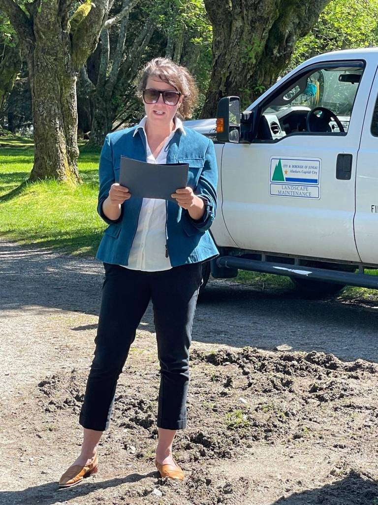 Juneau Assembly Member Christine Woll, standing in for Mayor Beth Weldon, reads a city proclamation celebrating the Evergreen Cemetery Arboretum and national Arbor Day on Monday, May 19, 2025. (Laurie Craig / For the Juneau Empire)