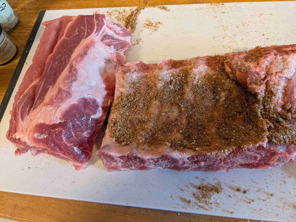 Adding a spice rub to a rack of baby back ribs. (Photo by Patty Schied)