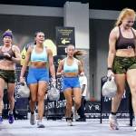 Chrish Newell, right, and partner Jess Contreras, far left, compete in the Farmers Carry during the HYROX 2025 Atlanta Doubles in late April. They qualified for the World Championships scheduled Sunday, June 15, 2025, in Chicago. (Photo courtesy Chris Newell)
