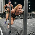 Chrish Newell, right, and partner Jess Contreras, left, at the Sled Push station during the HYROX 2025 Atlanta Doubles in late April. They qualified for the World Championships scheduled Sunday, June 15, 2025, in Chicago. (Photo courtesy Chrish Newell)