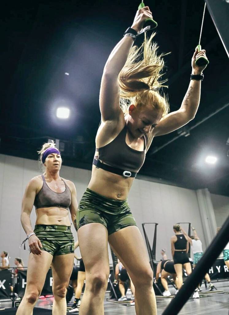 Chrish Newell, right, and partner Jess Contreras, left, at the Ski erg station during the HYROX 2025 Atlanta Doubles in late April. They qualified for the World Championships scheduled Sunday, June 15, 2025, in Chicago. (Photo courtesy Chrish Newell)
