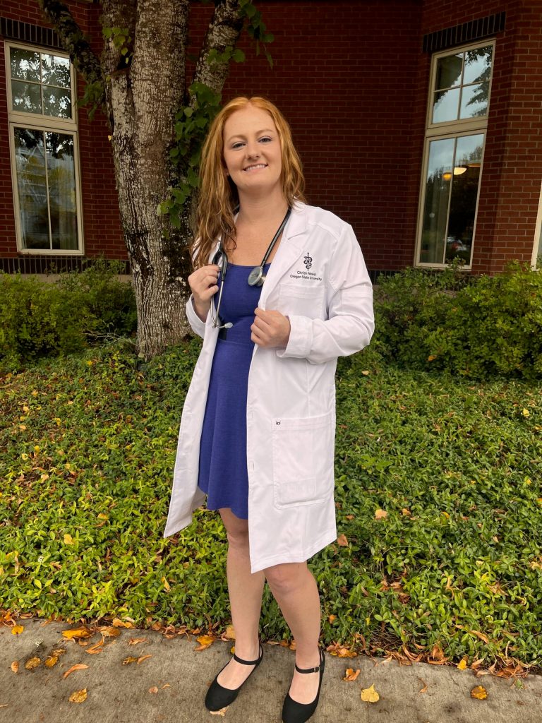 Chrish Newell at her White coat ceremony in 2023 just before starting vet school. She was seven weeks post ACL/meniscus reconstruction surgery at the time. (Photo courtesy Chrish Newell)