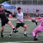 Juneau-Douglas High School: Yadaa.at Kalé senior Kai Ciambor touches a shot past Service sophomore keeper Nathaniel Thate and senior Matej Omalley (2) during the Crimson Bears win over Service to open the 2025 ASAA/First National Bank Alaska Soccer State Championships at Wasilla High School on Thursday, May 29, 2025. (Klas Stolpe / Juneau Empire)
