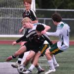 Juneau-Douglas High School: Yadaa.at Kalé senior Kellen Chester (8)battles for a ball during the Crimson Bears win over Service to open the 2025 ASAA/First National Bank Alaska Soccer State Championships at Wasilla High School on Thursday, May 29, 2025. (Klas Stolpe / Juneau Empire)