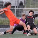 Juneau-Douglas High School: Yadaa.at Kalé freshman keeper Callen Walker and senior defender Kellen Chester (8) work for a ball against West Anchorage junior Luca Driscoll during the Crimson Bears 3-2 loss in extra time to the Eagles in the 2025 ASAA/First National Bank Alaska Soccer State Championship semifinals Friday at Wasilla High School. (Klas Stolpe / Juneau Empire)
