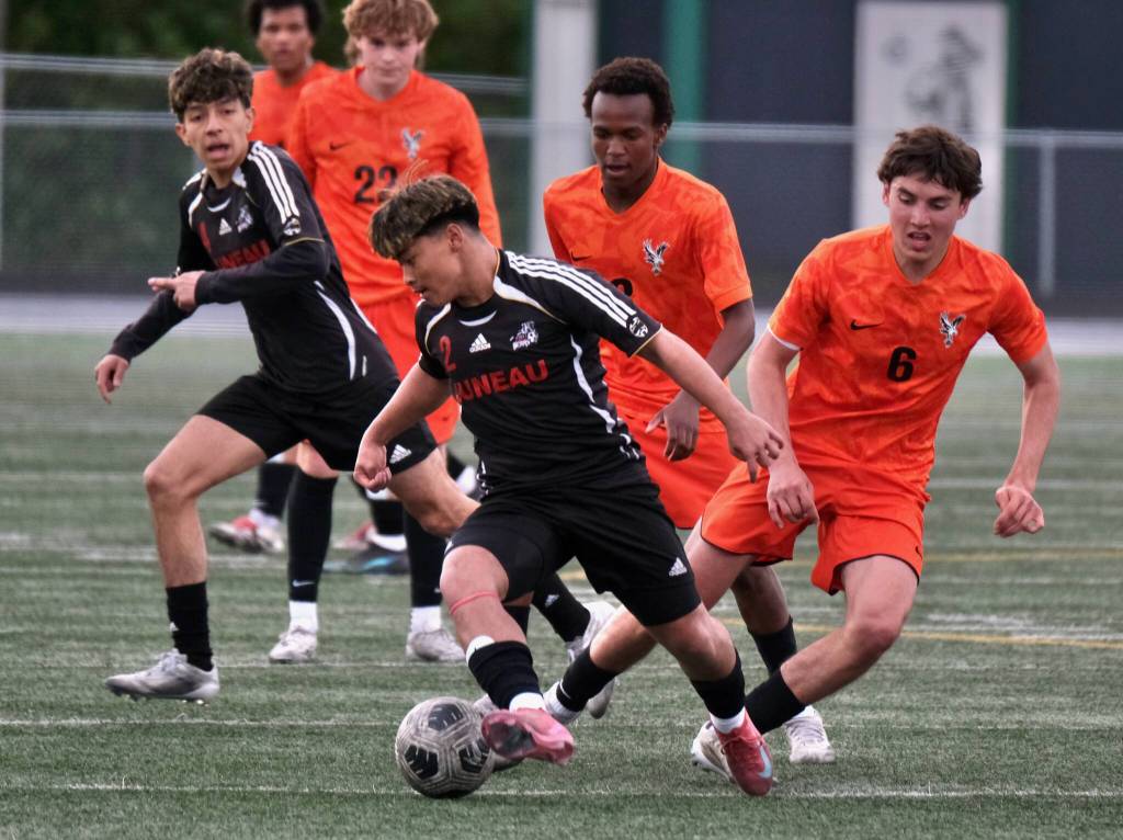 Juneau-Douglas High School: Yadaa.at Kalé sophomore Sonny Mazon (2) works a ball away from West Anchorage juniors Luca Driscoll (6) and Adoum Abakaarabdou (8) during the Crimson Bears 3-2 loss to the Eagles on Friday in the 2025 ASAA/First National Bank Alaska Soccer State Championship semifinals at Wasilla High School. (Klas Stolpe / Juneau Empire)
