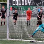 Juneau-Douglas High School: Yadaa.at Kalé senior Kai Ciambor hits a penalty kick past West Anchorage sophomore keeper Gideon Plikat during the Crimson Bears 3-2 loss in extra time to the Eagles in the 2025 ASAA/First National Bank Alaska Soccer State Championship semifinals Friday at Wasilla High School. (Klas Stolpe / Juneau Empire)