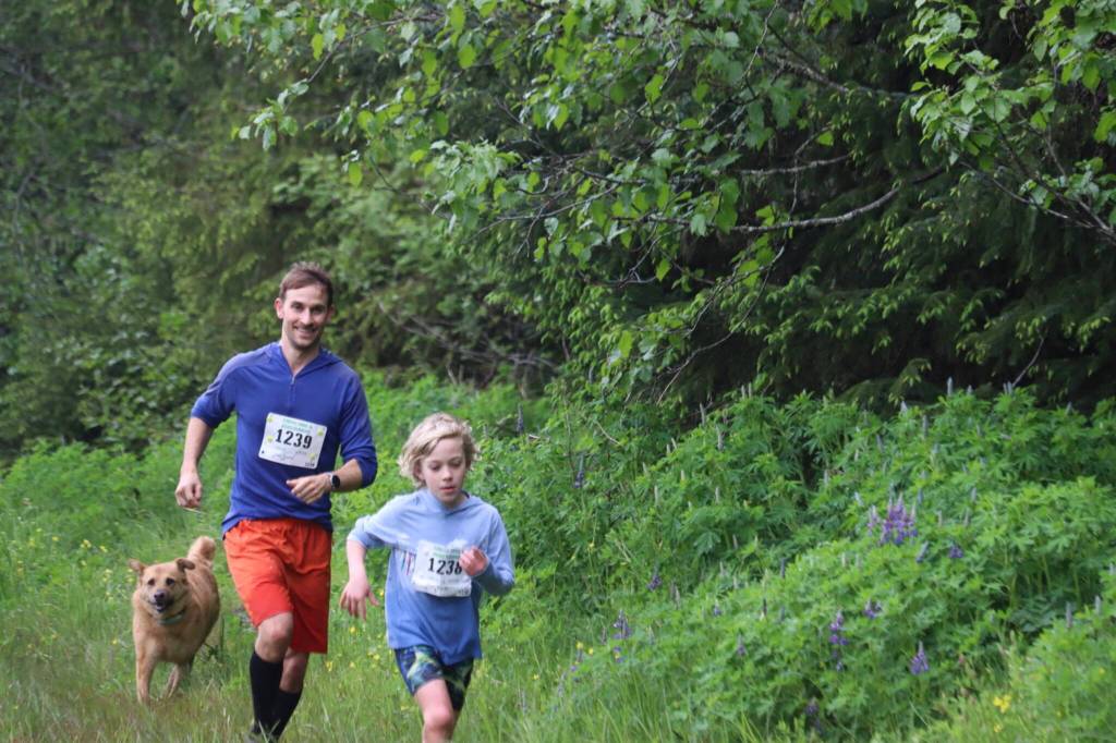 Finn Taintor, 8, and Luke Taintor, 37, return from the Gastineau Channel crossing at the 2025 Spring Tide Scramble on Saturday, May 31, 2025. (Ellie Ruel / Juneau Empire)