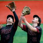 Juneau-Douglas High School: Yadaa.at Kalés Nate Fick (10) and Riley Fick (22) both reach for a pop-up during Juneau Douglass 14-12 loss to Sitka, losing the championship game of the Region V Baseball tournament at Norman Walker Field on Saturday. (Christopher Mullen / Ketchikan Daily News)