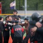 Juneau-Douglas High School: Yadaa.at Kalés Nate Fick is mobbed by team members after hitting a walk-off RBI single to give Juneau Douglas a 4-3 victory over Ketchikan on the second day of the Region V Baseball tournament at Norman Walker Field on Friday, May 30, 2025. (Christopher Mullen/Ketchikan Daily News)