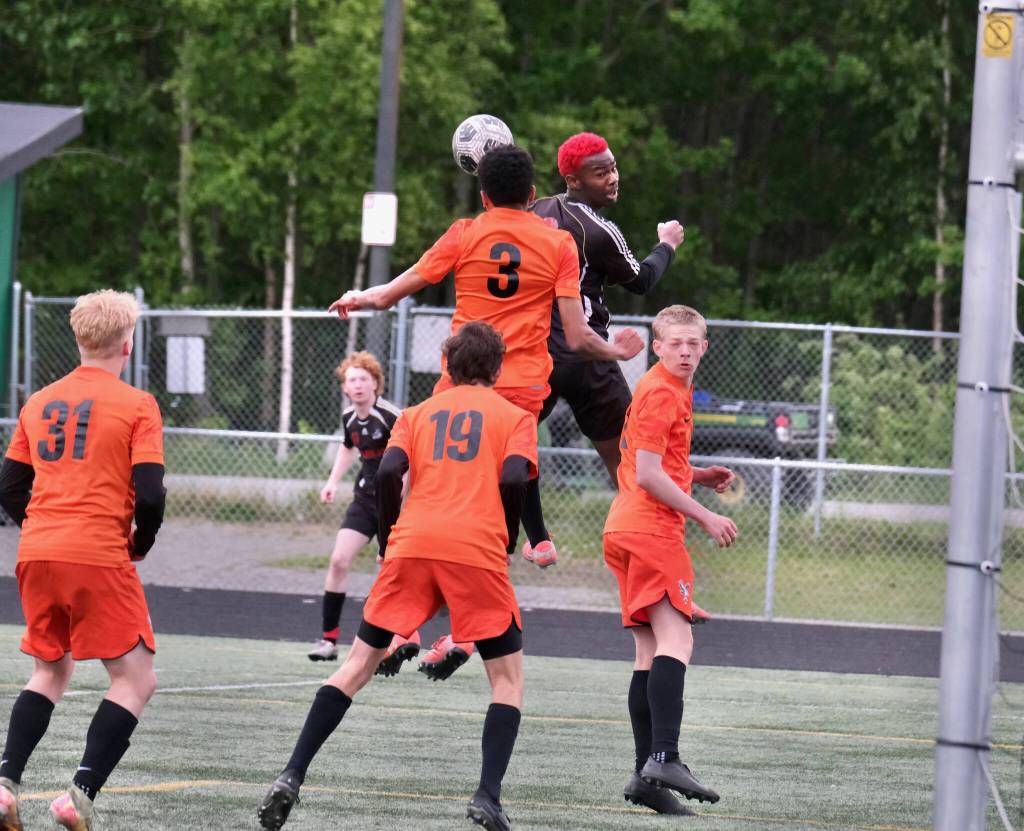 Juneau-Douglas High School: Yadaa.at Kalé senior Ahmir Parker heads a ball among West Anchorage players during the Crimson Bears 3-2 loss in extra time to the Eagles in the 2025 ASAA/First National Bank Alaska Soccer State Championship semifinals Friday at Wasilla High School. (Klas Stolpe / Juneau Empire)