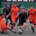 Juneau-Douglas High School: Yadaa.at Kalé senior Kai Ciambor (14) moves the ball against West Anchorage senior Amine Abakar, left, Michael Njoku and Porter Youngman. during the Crimson Bears 3-2 loss in extra time to the Eagles in the 2025 ASAA/First National Bank Alaska Soccer State Championship semifinals Friday at Wasilla High School. (Klas Stolpe / Juneau Empire)