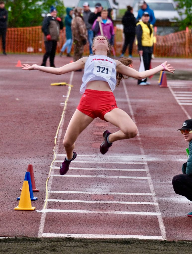 Juneau-Douglas High School: Yadaa.at Kalé senior Cailynn Baxter soars in the finals of the long jump during the 2025 ASAA/First Bank Alaska State Track & Field Championships on Saturday at Anchorages Dimond High School. (Klas Stolpe / Juneau Empire)