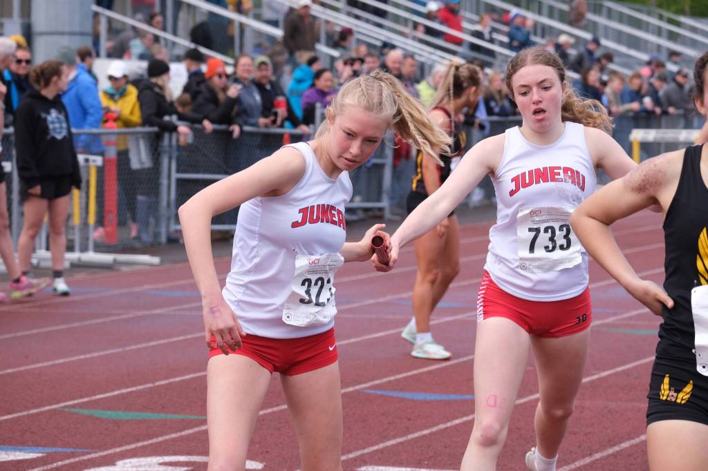 Juneau-Douglas High School: Yadaa.at Kalés Sigrid Eller takes the baton from Siena Farr during the girls 4x800 relay during the 2025 ASAA/First Bank Alaska State Track & Field Championships on Saturday at Anchorages Dimond High School. (Klas Stolpe / Juneau Empire)