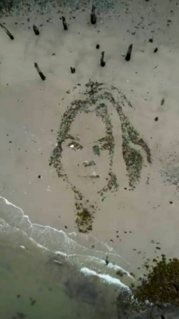 A profile of a South African model is seen on the surface of Sandy Beach in late May of 2025, about six months after its completion by artist Blake Byers. (Still shot from video by Blake Byers)