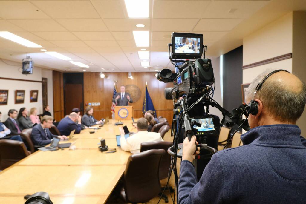 Michael Penn, a Gavel production technician broadcasts a live press conference with Gov. Mike Dunleavy following his second veto of education funding legislation on May 19, 2025. (Corinne Smith/Alaska Beacon)