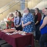 Steve Henrikson (center) smiles with museum colleagues over the Alaska State Museums 125th birthday cake on Friday, June 6, 2025. (Natalie Buttner / Juneau Empire)