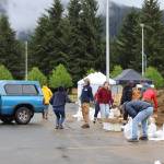 Mendenhall Valley residents fill sandbags at the sandbag pickup/open house event on Saturday, June 7, 2025, at Thunder Mountain Middle School. (Ellie Ruel / Juneau Empire)