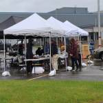 Volunteers from the city, Red Cross, and Tlingit and Haida answer flood questions at the sandbag pickup/open house event on Saturday, June 7, 2025, at Thunder Mountain Middle School. (Ellie Ruel / Juneau Empire)