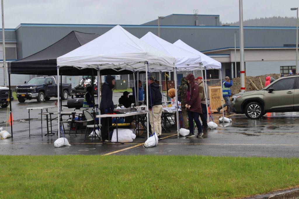 Volunteers from the city, Red Cross, and Tlingit and Haida answer flood questions at the sandbag pickup/open house event on Saturday, June 7, 2025, at Thunder Mountain Middle School. (Ellie Ruel / Juneau Empire)