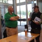 Insurance agent Emil Mackey discusses flood insurance with a Valley resident at the Juneau Flood Preparedness Workshop at the Mendenhall Valley Public Library on Saturday, Jun 7, 2025 (Ellie Ruel / Juneau Empire)