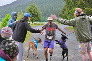 Stinky Rats Jason Norat is congratulated by teammates as he finishes the Seacoast Relay at the Eagle Beach State Park outer beach picnic shelter on Sunday, June 8, 2025. (Klas Stolpe / Juneau Empire)