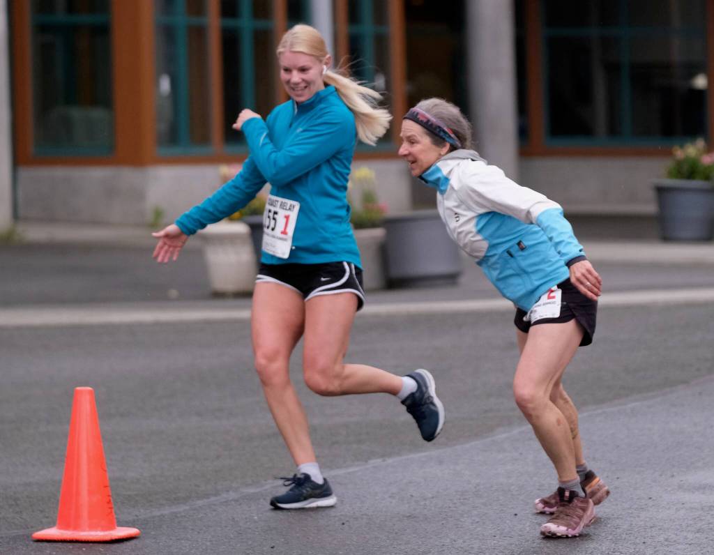 Magy Elliott of team Four Moms, One Dad hands off to Cecile Elliott during the Seacoast Relay at the University of Alaska Southeast campus on Sunday, June 8, 2025. (Klas Stolpe / Juneau Empire)