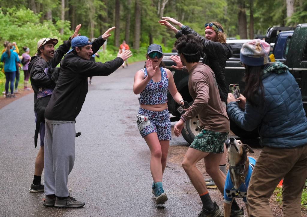 The Stinky Rats Kristen Strom hands off to Sam Fernandez at Lena Beach Picnic Area during the Seacoast Relay on Sunday, June 8, 2025. (Klas Stolpe / Juneau Empire)