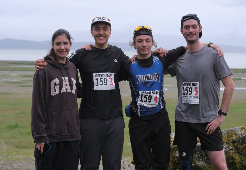 Snow Doubts Trinity Jackson, Ricardo Worl, Finley Hightower and Justin Sleppy at the finish line of the Seacoast Relay at the Eagle Beach State Park outer beach picnic shelter on Sunday, June 8, 2025. (Klas Stolpe / Juneau Empire)
