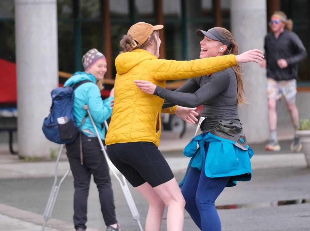 Runners embrace during the Seacoast Relay at the University of Alaska Southeast campus Sunday, June 8, 2025. (Klas Stolpe / Juneau Empire)
