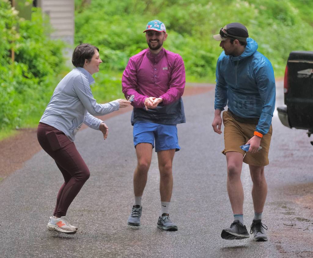 Dimond Dogs David Fure hands off to Sophie Staires and Hank Shell at Lena Beach Picnic Area during the Seacoast Relay on Sunday, June 8, 2025. (Klas Stolpe / Juneau Empire)