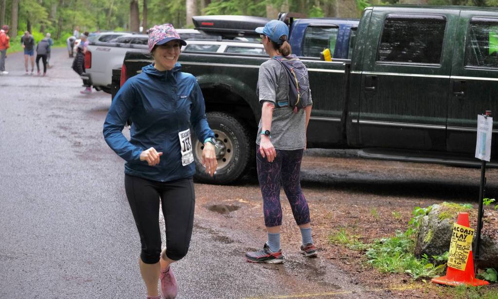 Three Marmoteers runner Christy Gentemann takes a hand off from Becky Bohrer at Lena Beach Picnic Area during the Seacoast Relay on Sunday, June 8, 2025. (Klas Stolpe / Juneau Empire)
