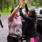 Team Sole Sisters Lacey Sanders hands off to Julie Mesdag at Lena Beach Picnic Area during the Seacoast Relay on Sunday, June 8, 2025. (Klas Stolpe / Juneau Empire)