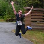 Samantha Blommer of team Sole Sisters jumps for joy as she approaches the finish line of the Seacoast Relay at the Eagle Beach State Park outer beach picnic shelter on Sunday, June 8, 2025. (Klas Stolpe / Juneau Empire)