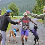 Stinky Rats Jason Norat is congratulated by teammates as he finishes the Seacoast Relay at the Eagle Beach State Park outer beach picnic shelter on Sunday, June 8, 2025. (Klas Stolpe / Juneau Empire)