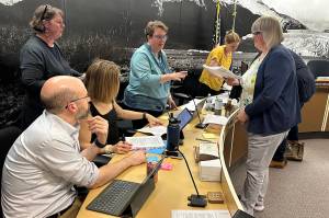 Juneau Mayor Beth Weldon (right) confers with city administrative leaders during a break at a Juneau Assembly meeting on Monday, June 9, 2025, at City Hall. (Mark Sabbatini / Juneau Empire)