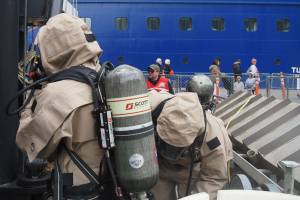 National Guard members put on hazmat suits before entering the simulation area on Monday, June 9, 2025. (Natalie Buttner / Juneau Empire)